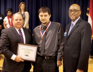 Michael Joyner (center) receives the NCCCS Academic Excellence Award from Steve Shook (left), State Board Member of the North Carolina Community College System, while RCCC President Dr. Michael Elam is shown at right. Contributed Photo
