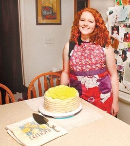 Hannah Winslow displays just one of her unique desserts – a sweet tea cake with whipped cream frosting – crafted in the kitchen of her home near Sunbury. | Staff Photo by Cal Bryant
