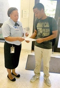 Phi Theta Kappa Honor Society member Brittany Lopez assists a new student at Halifax Community College. | Contributed Photo