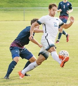 Dennis Roule (#25) gains control of the ball during a recent outing. Roule and the Hawks fought to a 2-2 draw on Tuesday at Belmont Abbey College and will travel today (Saturday) to Pembroke University. | Photo by Angie Todd