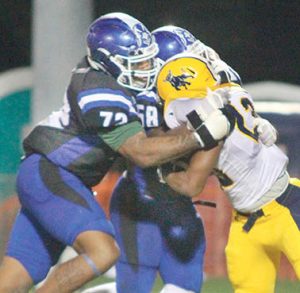 Johnson C. Smith’s Tromecio Summers (right) is wrapped up by Chowan defenders Kamaree Alcorn (left) and Chris Rodgers after a short gain. The Hawks defense kept the Golden Bulls offense in check, limiting their guests to 251 total yards. 