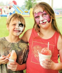 Dallas and Hayden Edwards, both sporting freshly applied face paint, enjoy their ice cream at Saturday’s event in Aulander.